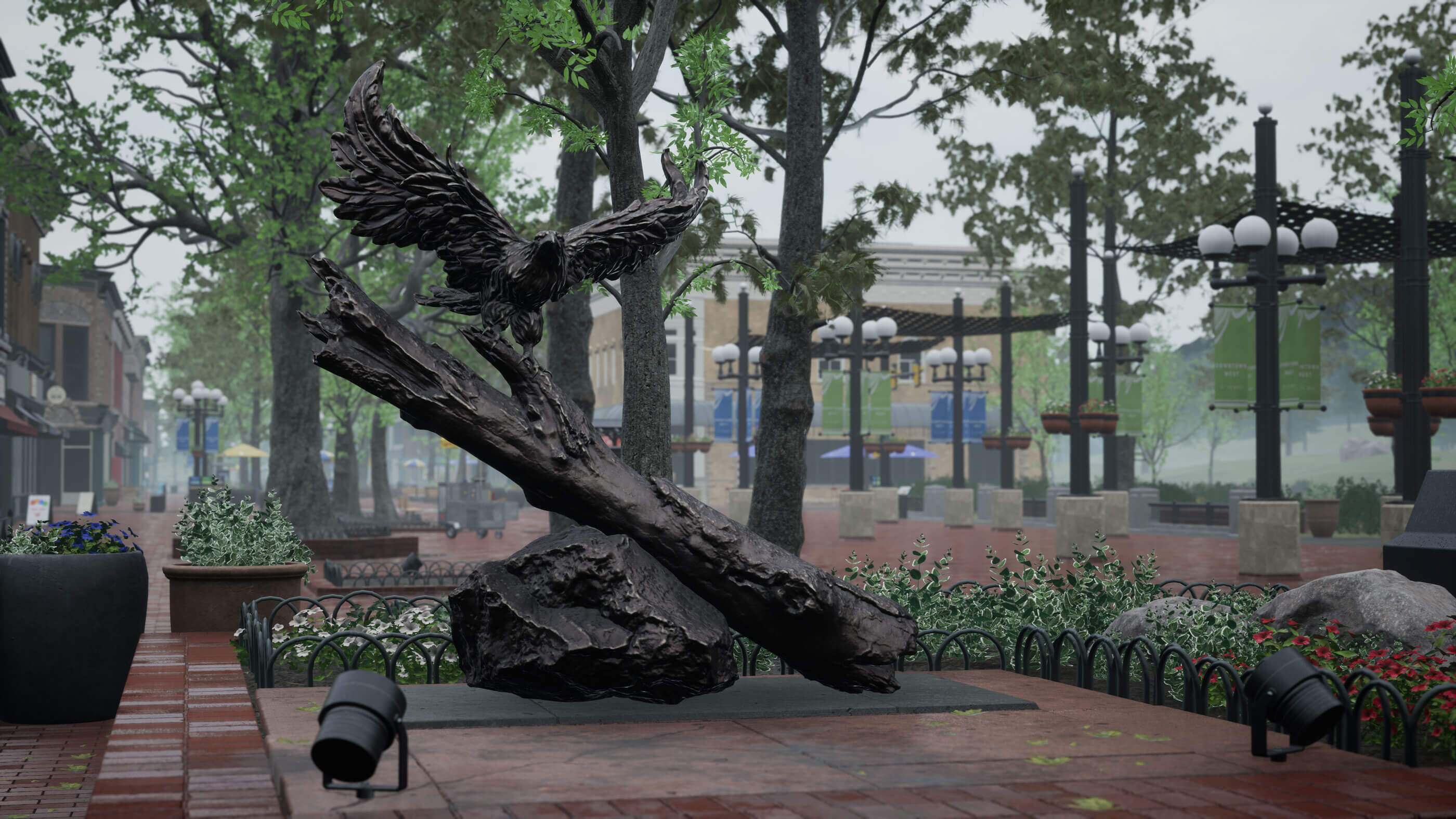 A plaza area on a rainy day with a statue of an eagle.
