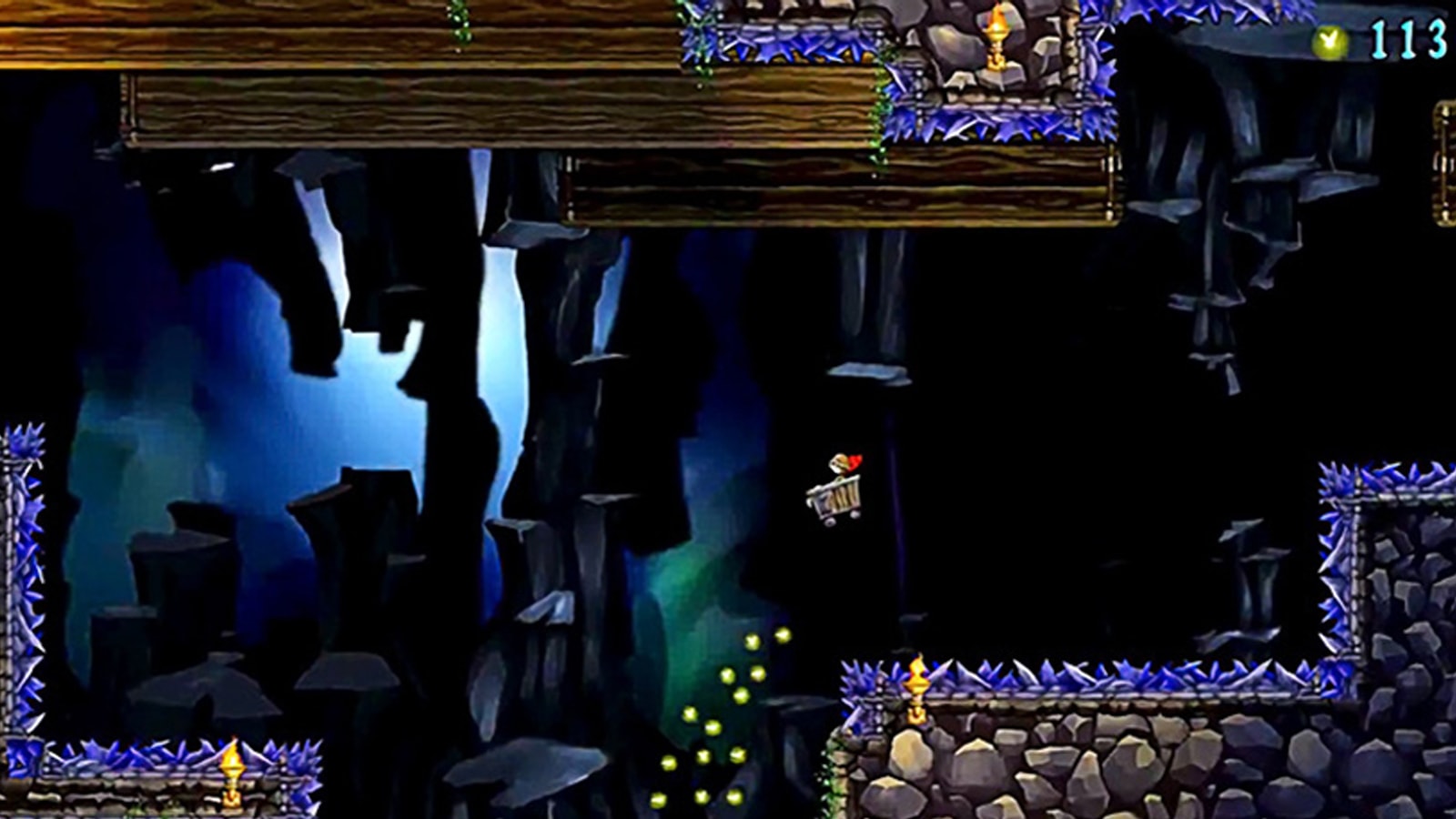 A caped boy riding a mine cart soars through the air in a large underground cavern. 