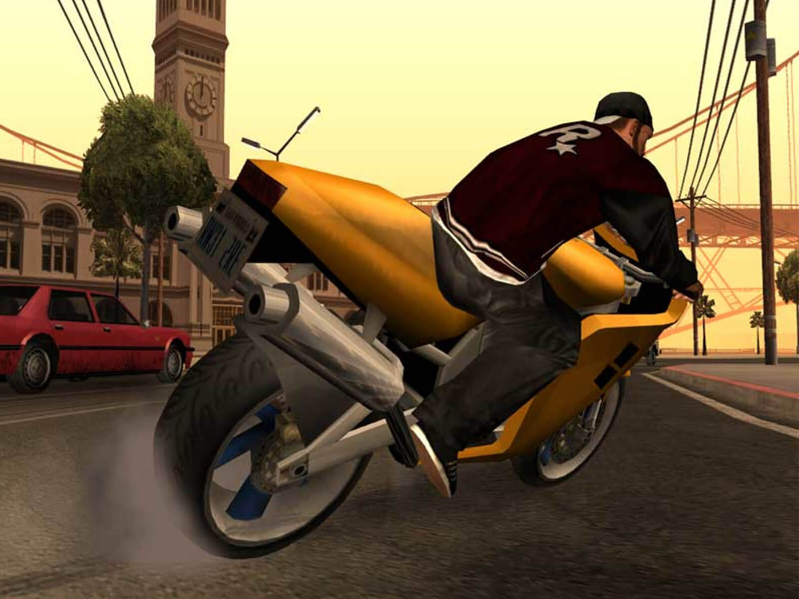 A screenshot from Grand Theft Auto: San Andreas of a man in a jacket with the Rockstar logo on it riding a gold motorcycle.