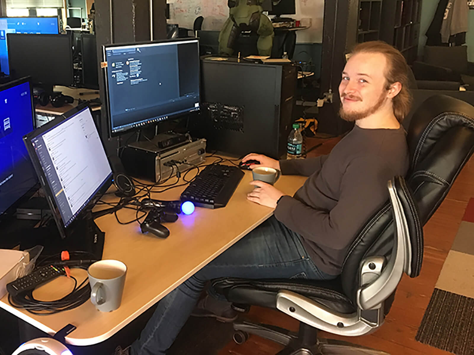 DigiPen alumnus Ian Shores sits at his desk at the Highwire Games office