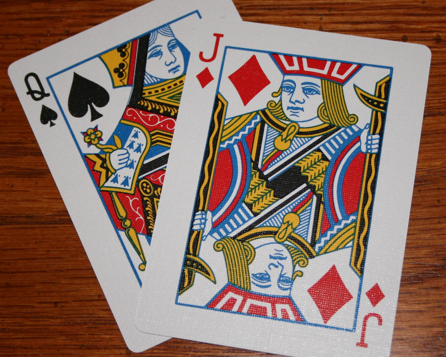 A queen of aces and jack of diamonds card.
