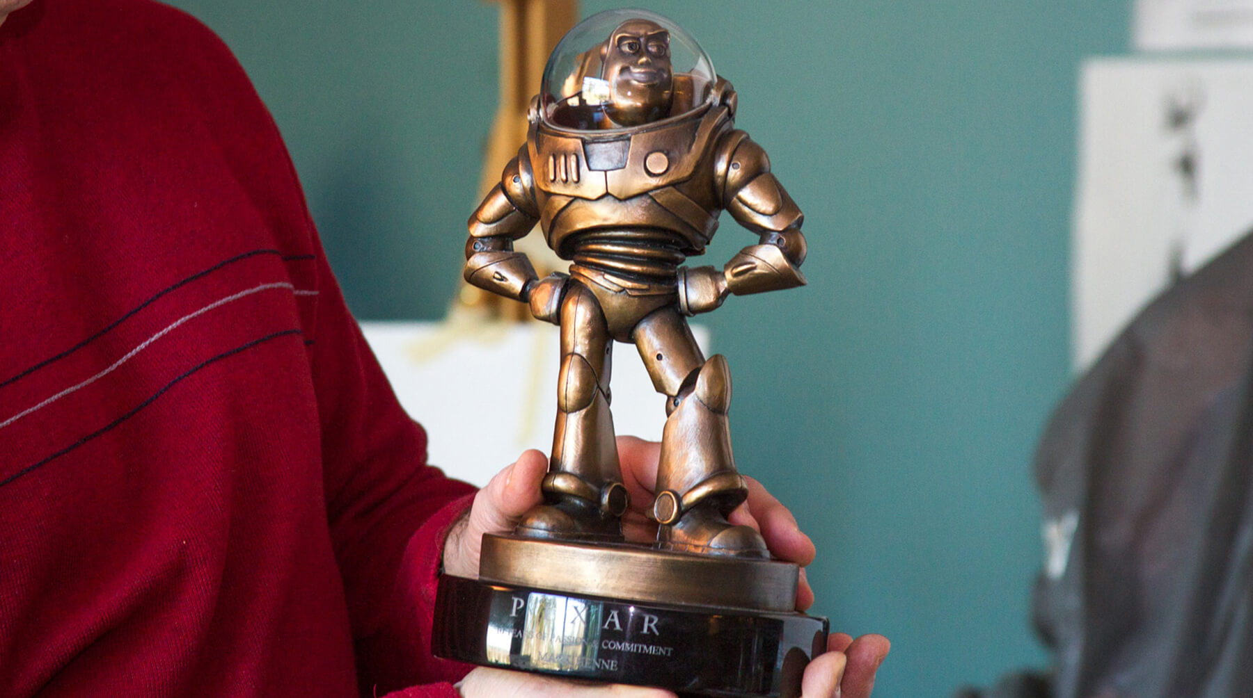 DigiPen Digital Arts lecturer Mark Henne shows his Pixar Award for Passionate Commitment, a bronze Buzz Lightyear trophy