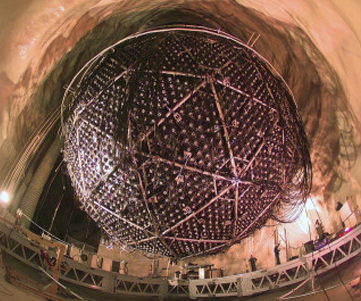 The SNO Detector, which resembles a giant golf ball, is suspended from the cavern ceiling