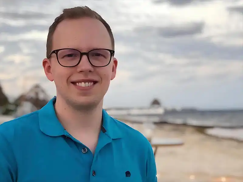 DigiPen graduate Cody Luitjens smiles on a beach.