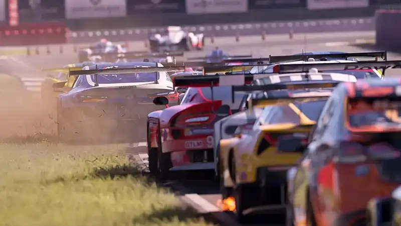 Racing cars bearing spoilers and branded bumper stickers seen from the rear driving down a racetrack.