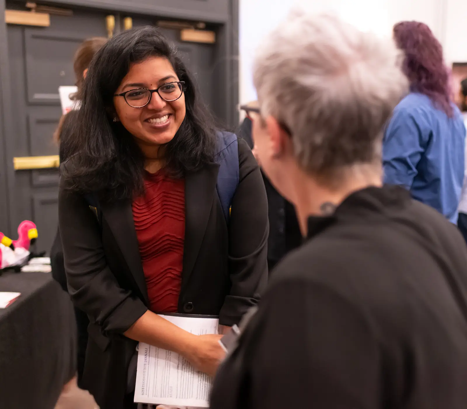 A DigiPen student introducing herself to a potential employer during an internship fair.