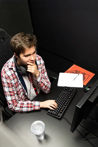 A DigiPen student studying at a computer.