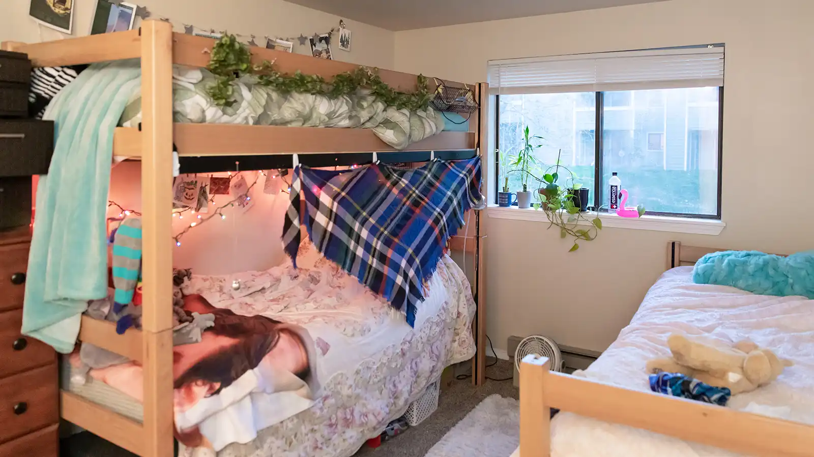 Student bedroom with a bunkbed and desk.