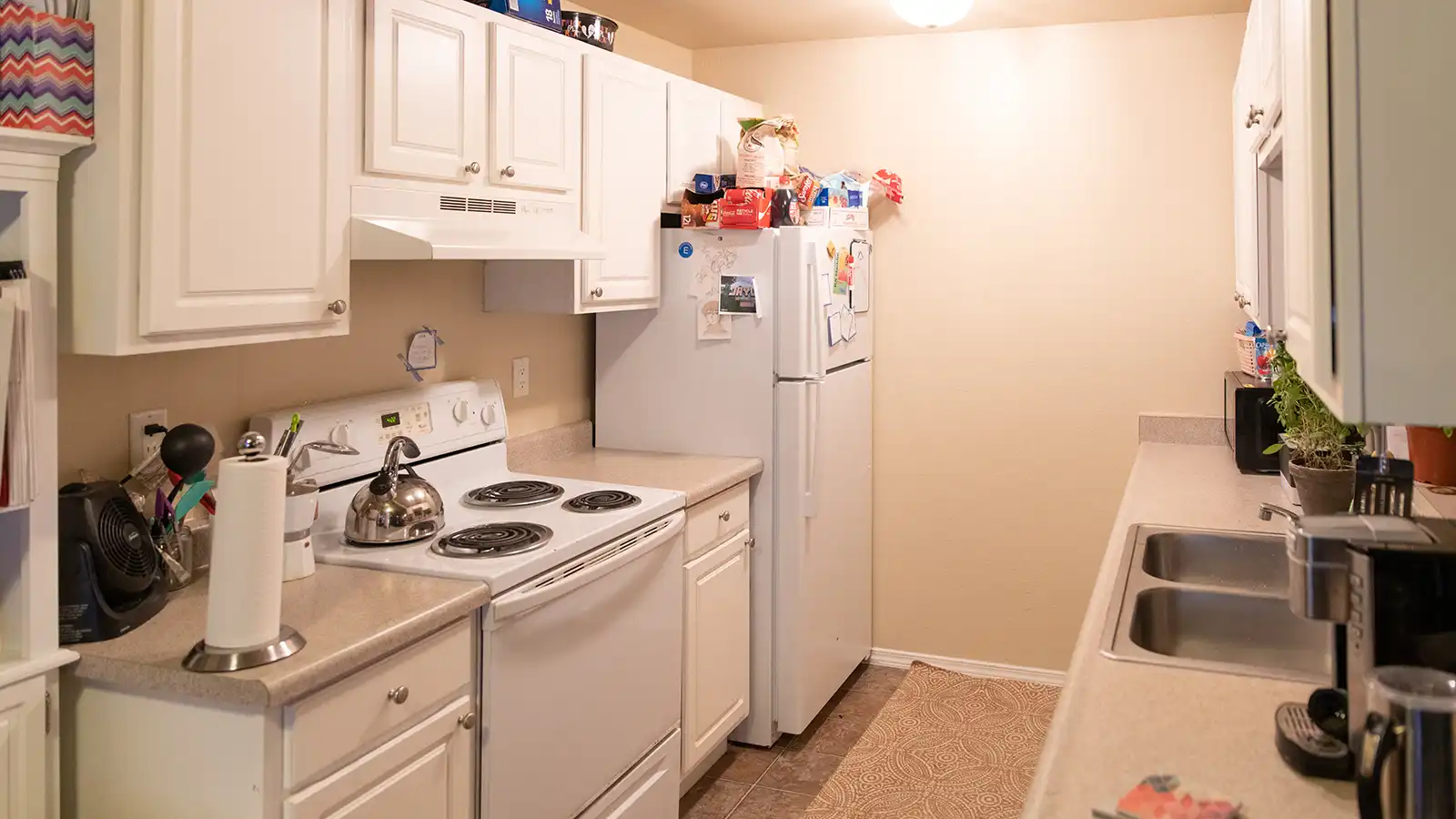 Student housing kitchen with various appliances.