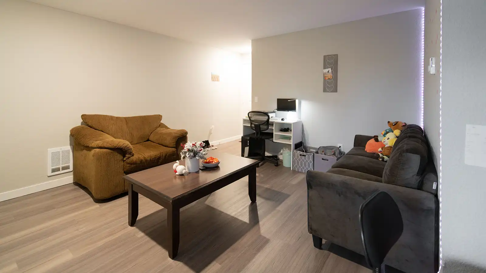 A living room with furniture and a desk.