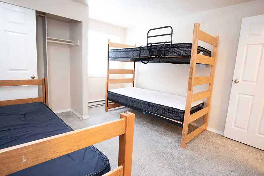 Bunk bed and a separate bed in a bedroom.