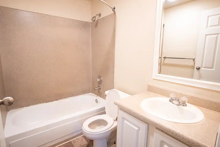 Bathroom with sink, toilet, and shower.