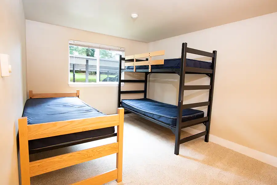 A bunk bed and separate bed in a bedroom.