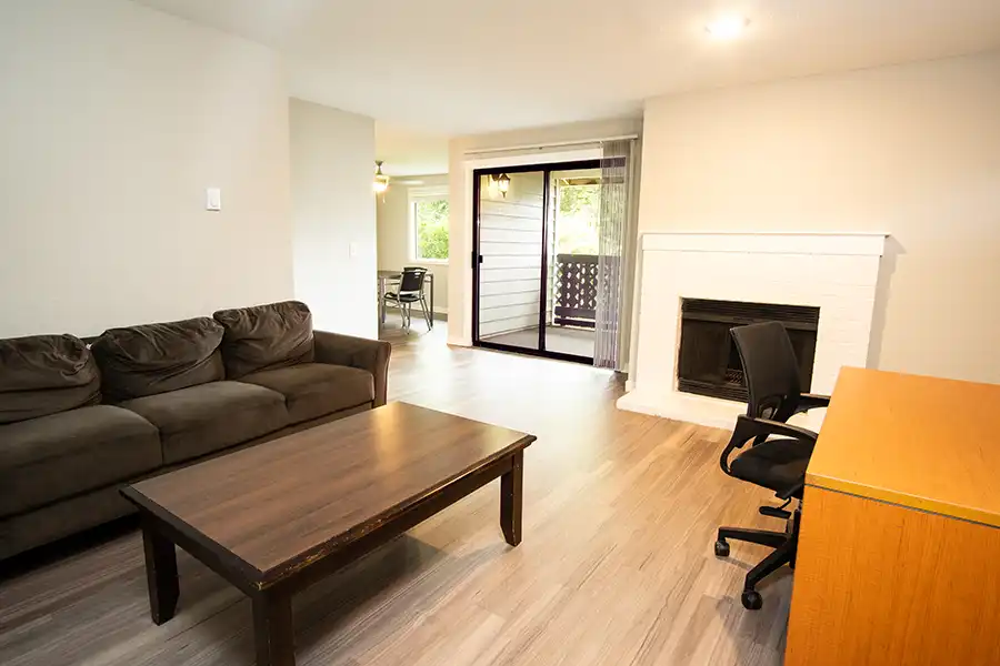 View of living room in apartment with furniture.