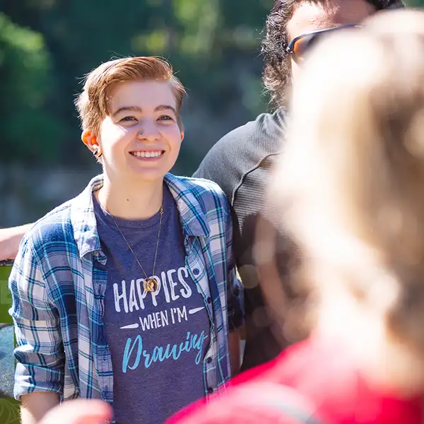 A DigiPen student stands smiling outdoors.