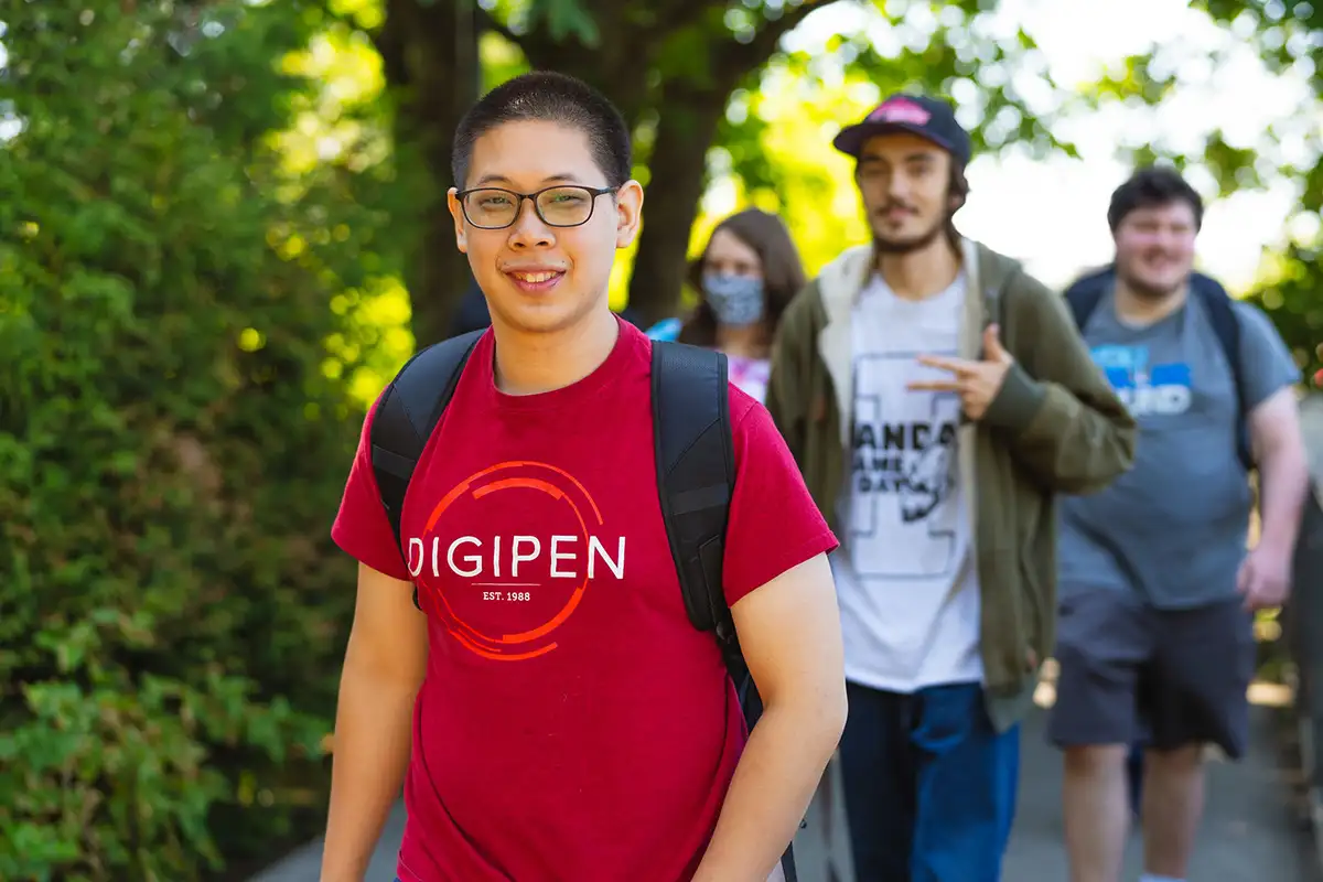 A group of DigiPen student walking outdoors smiling.