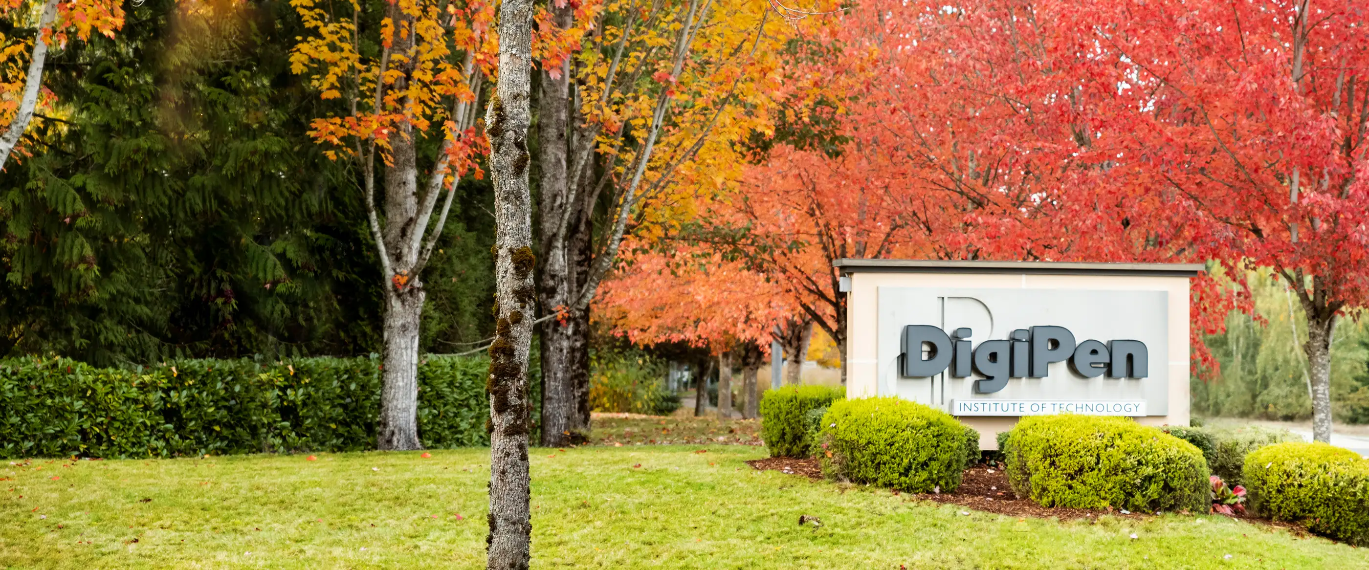 DigiPen campus exterior sign during autumn.