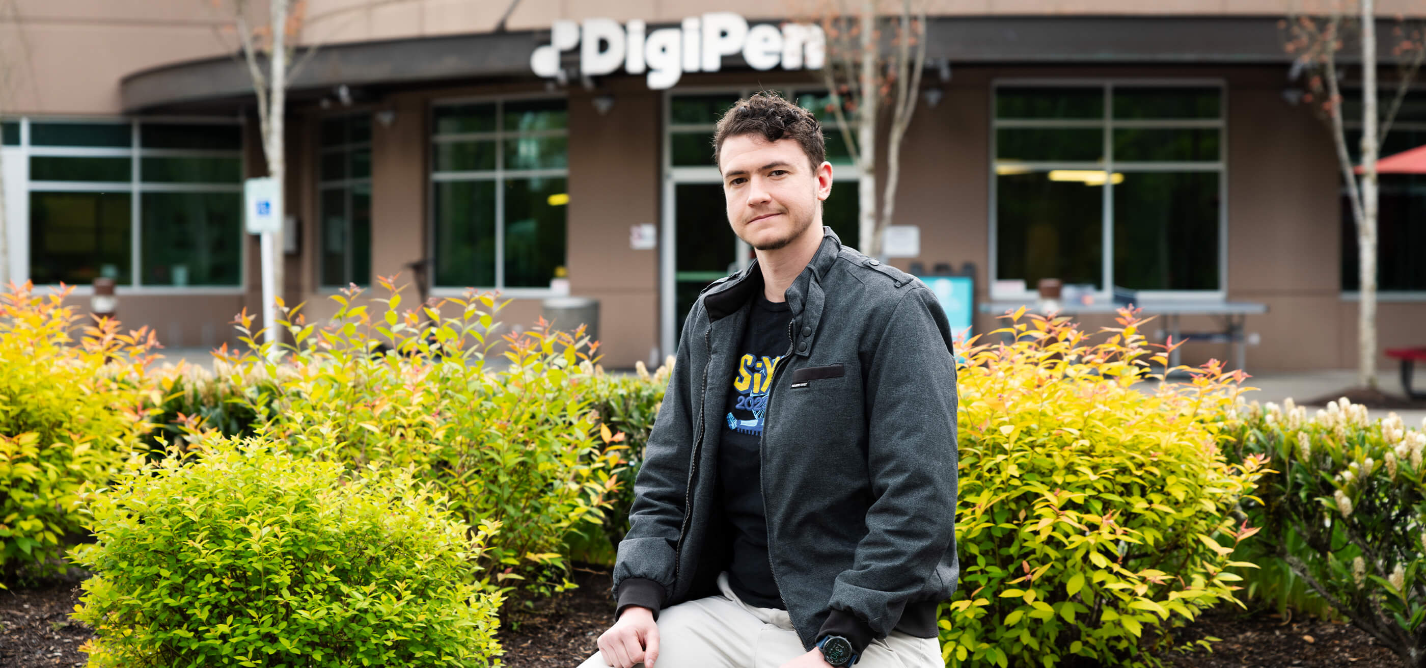 Outgoing DigiPen Student Union President Li Buam stands in front of the DigiPen Campus