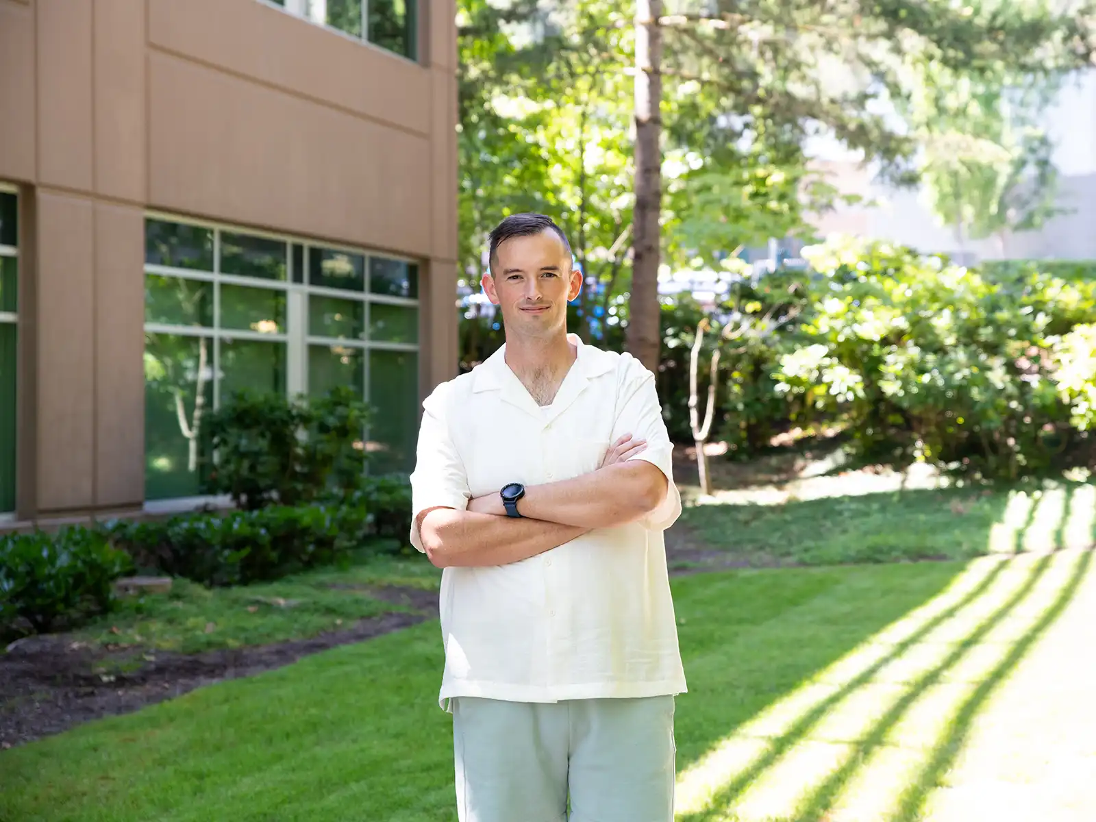 Alex Williams stands on the lawn outside the DigiPen campus building.