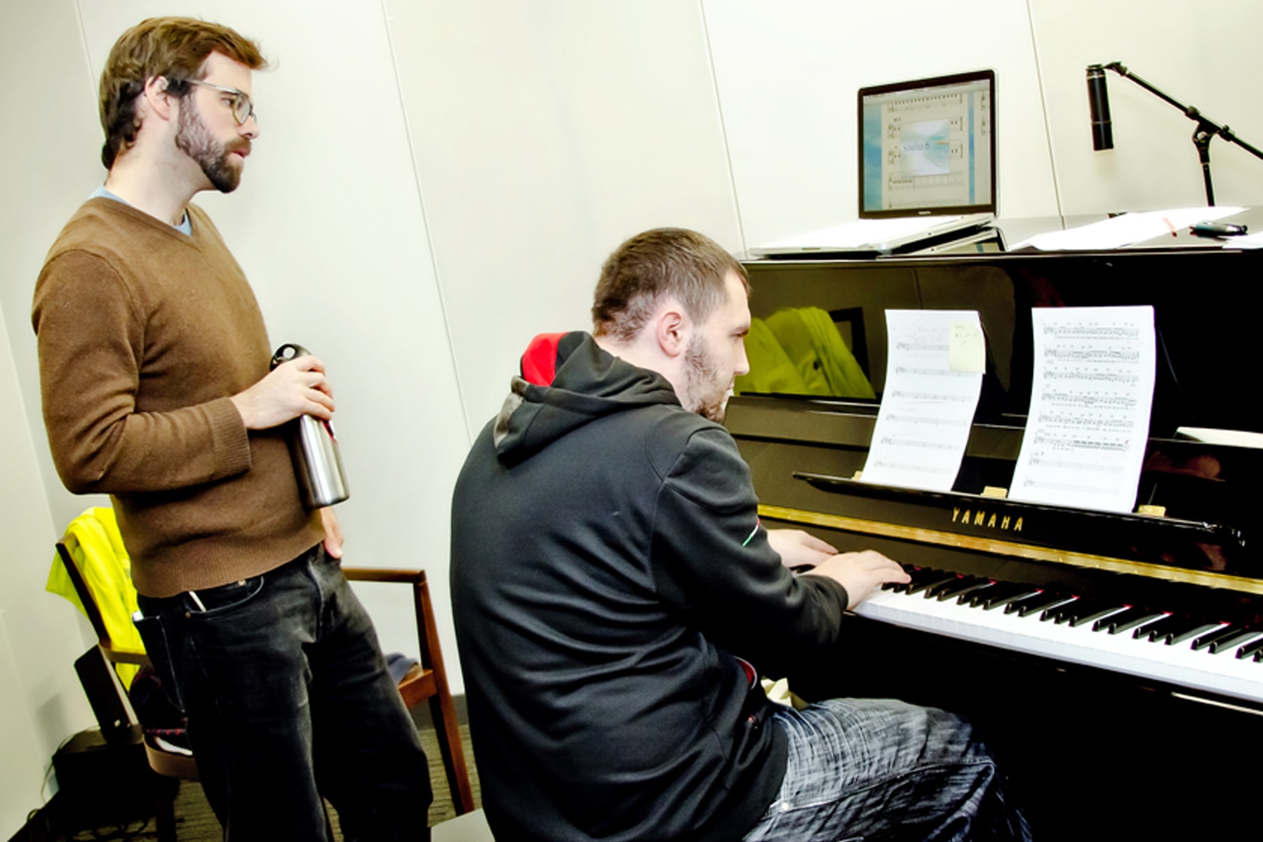 DigiPen students playing the piano in the new sound lab recording studio